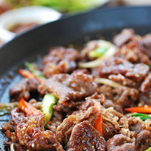 bulgogi cooked on a grill pan with lettuce wraps