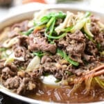 Bulgogi being cooked on a Korean dome shape grill pan