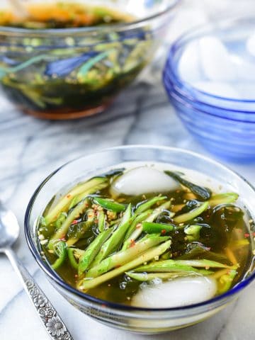 Korean cold cucumber soup in a glass bowl