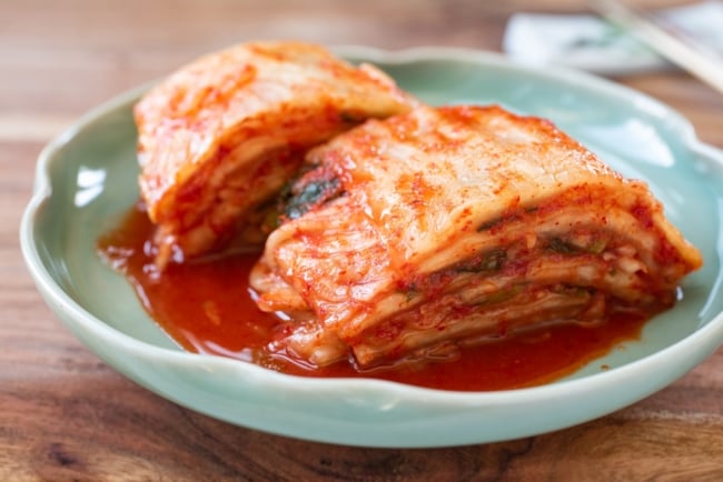 cut traditional kimchi in a green plate