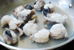 cooking monkfish in a pan