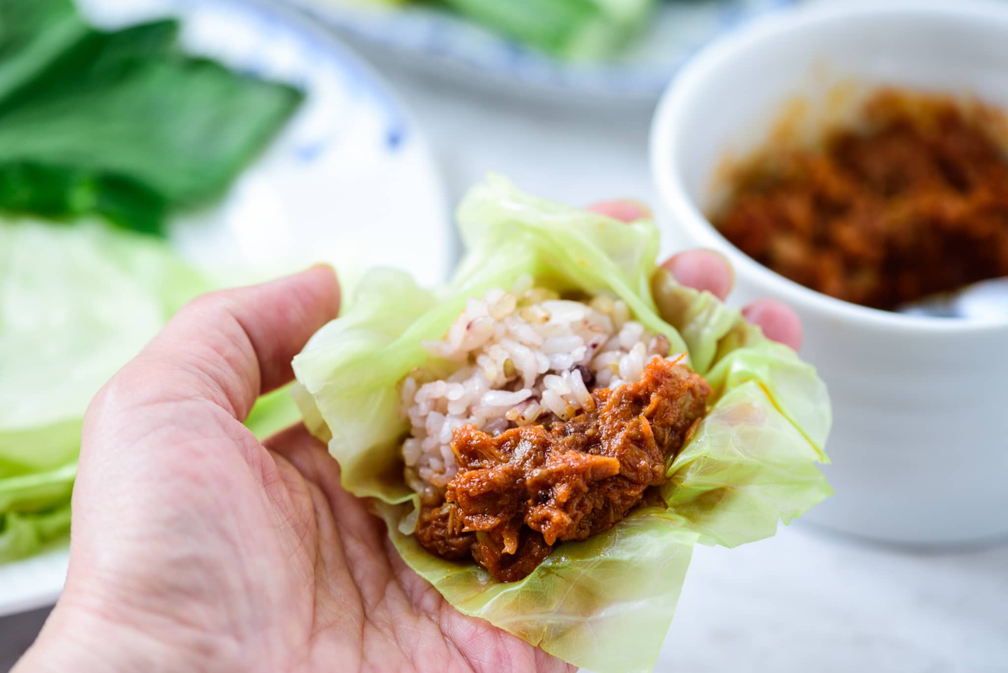 Wrapping rice and sauce in a cabbage leaf