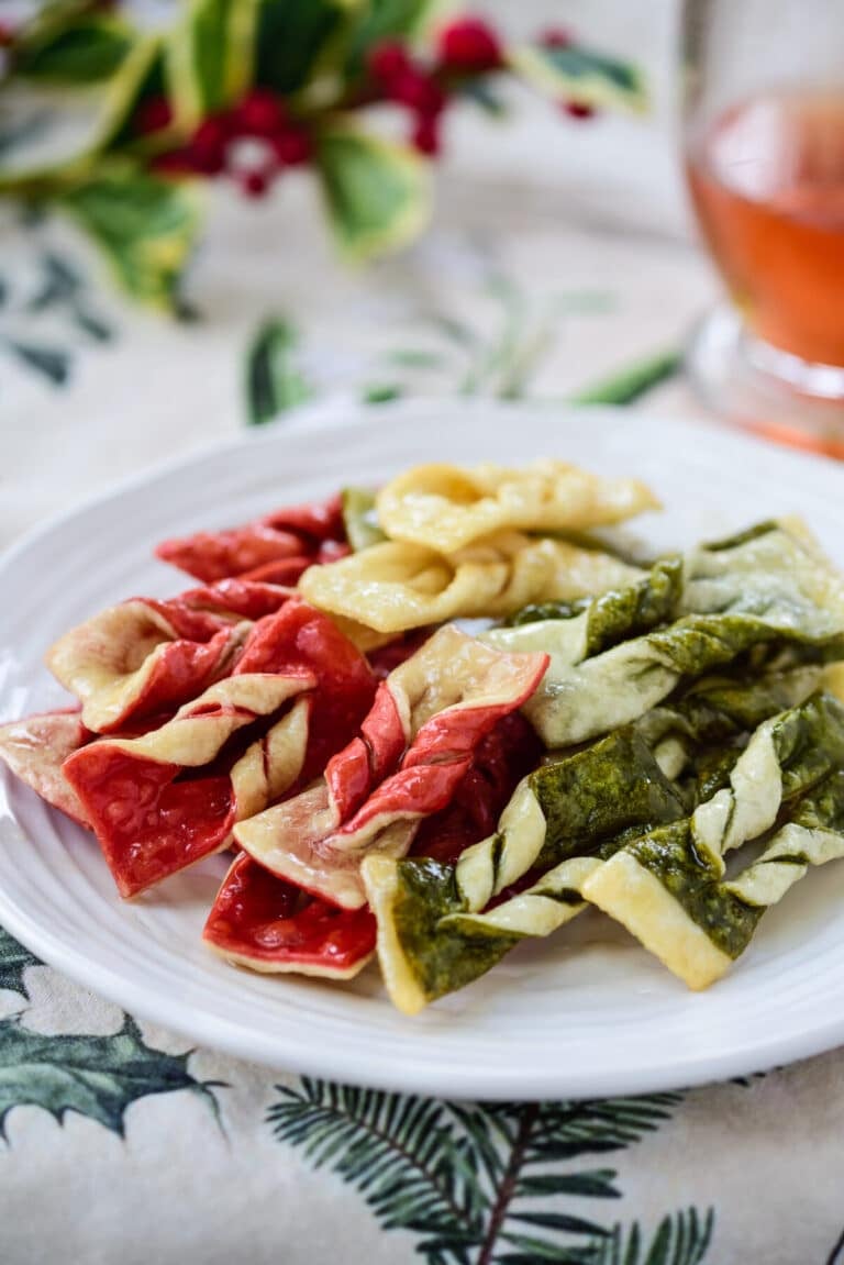 Maejakgwa (twisted ginger cookies) Korean twisted ginger cookies in red, green and white with a glass cup of tea on Christmas background