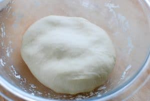Homemade dumpling wrapper dough in a pirex bowl
