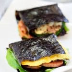 Two folded kimbap on a white plate