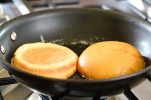 Toasting hamburger bun in a pan