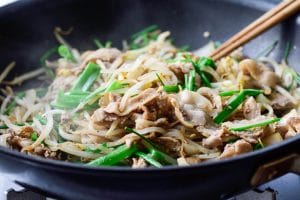 Stir frying pork and bean sprouts in a pan