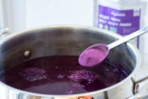 adding a spoonful of purple sweet potato powder into rice punch