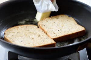 toasting bread in a pan with butter