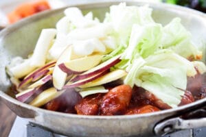 Cooking spicy chicken with cabbage, sweet potatoes and rice cakes