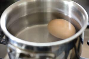 boiling an egg in a small pot