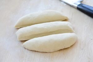 cutting the dumpling dough into 3 logs