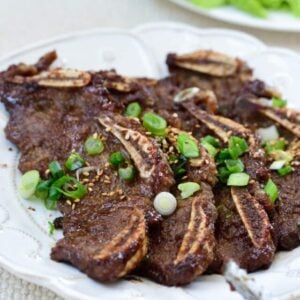 Korean beef short ribs in a plate with lettuce in the background